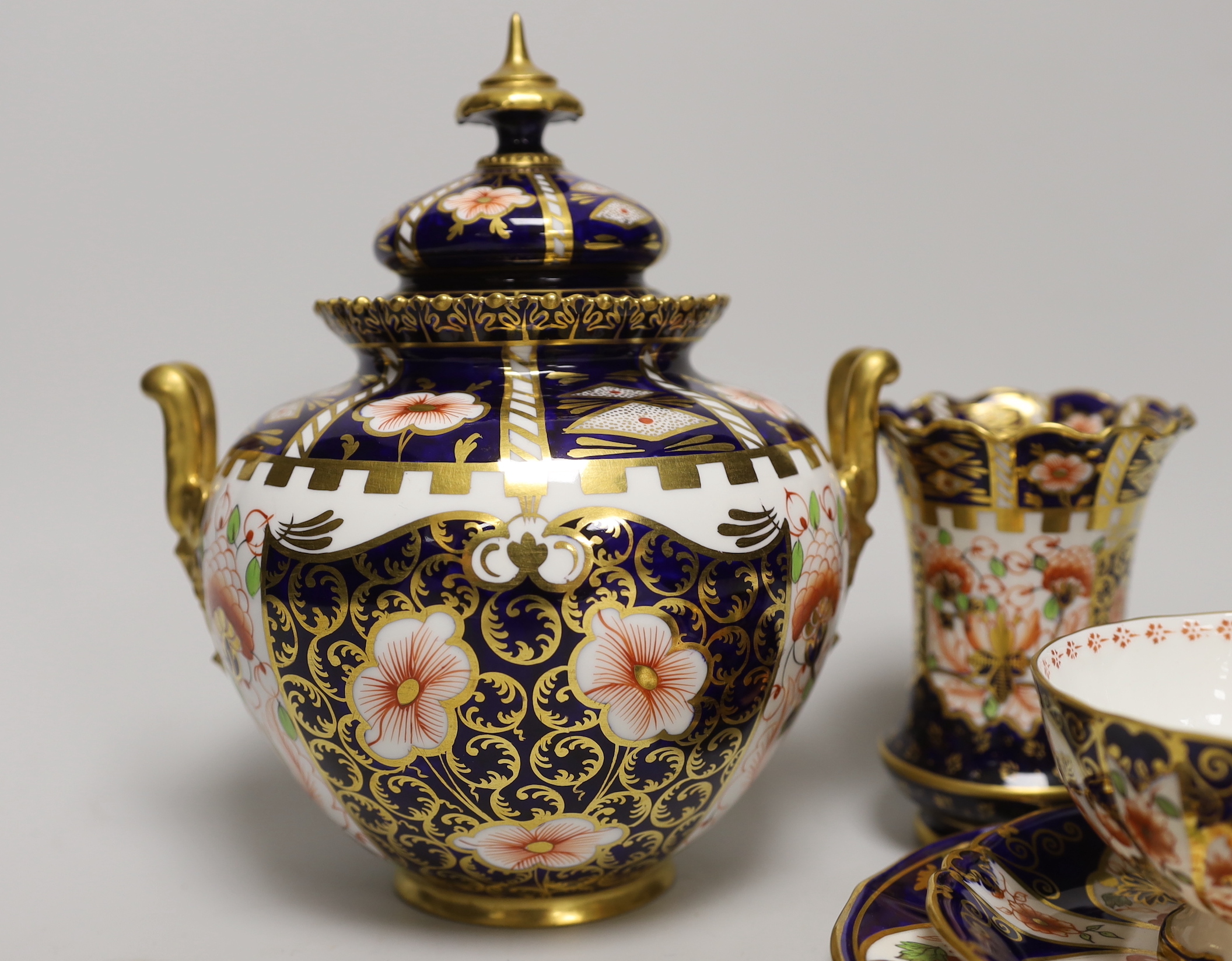Seven pieces of Royal Crown Derby Imari porcelain including a trio and twin handled jar and cover, the largest 21cm high